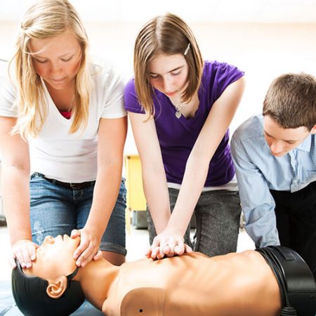 Students performing CPR on a dummy patient