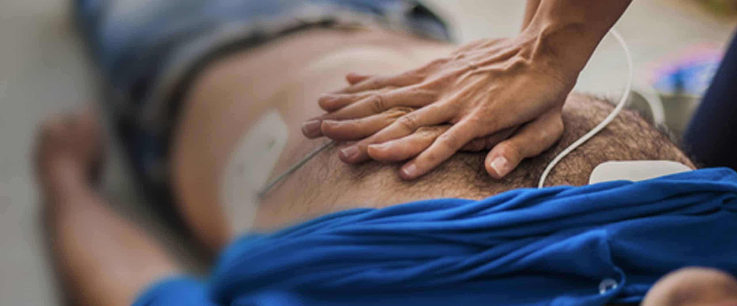 Close up of hands performing CPR on a patient